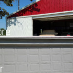 A sliding door retrofitted to an overhead garage door